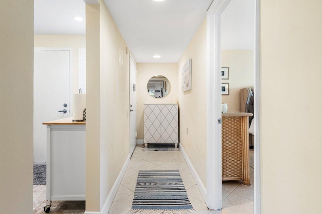 corridor featuring light tile patterned floors