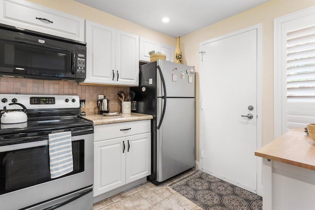 kitchen with white cabinets, light tile patterned floors, stainless steel appliances, and tasteful backsplash