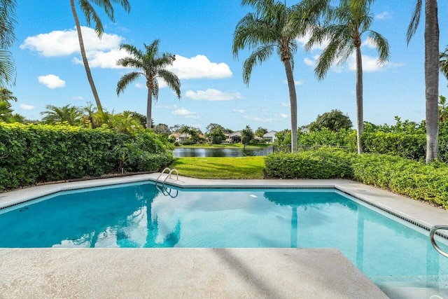 view of swimming pool with a water view