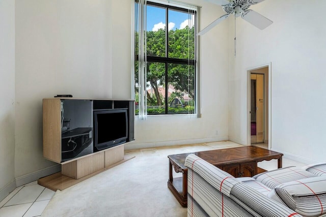 tiled living room featuring ceiling fan