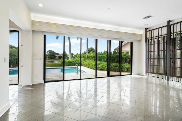 tiled spare room featuring plenty of natural light