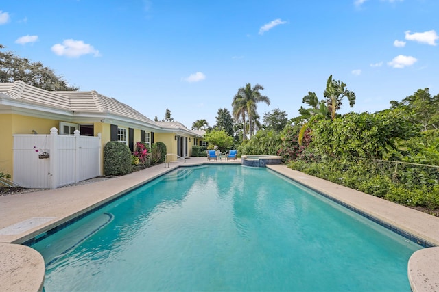 view of swimming pool with an in ground hot tub and a patio