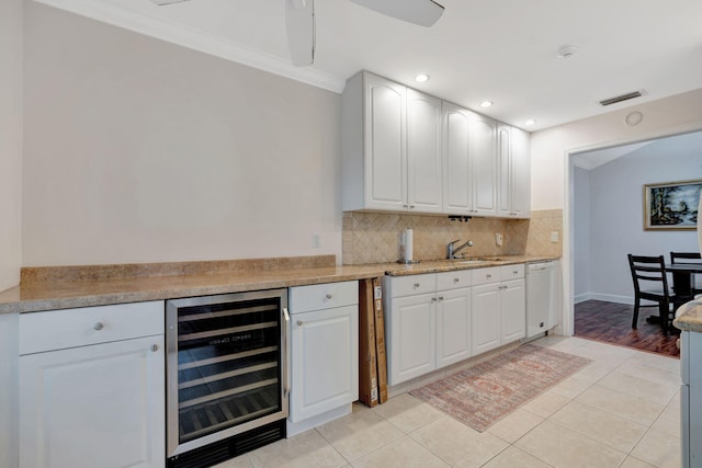 kitchen featuring dishwasher, white cabinetry, wine cooler, and light tile patterned flooring