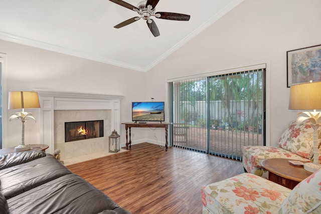 living room with high vaulted ceiling, wood-type flooring, ornamental molding, and a premium fireplace