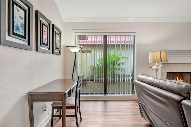 interior space featuring hardwood / wood-style flooring, ornamental molding, and a premium fireplace