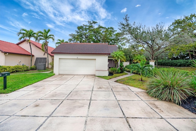 view of front of house featuring a garage and a front lawn