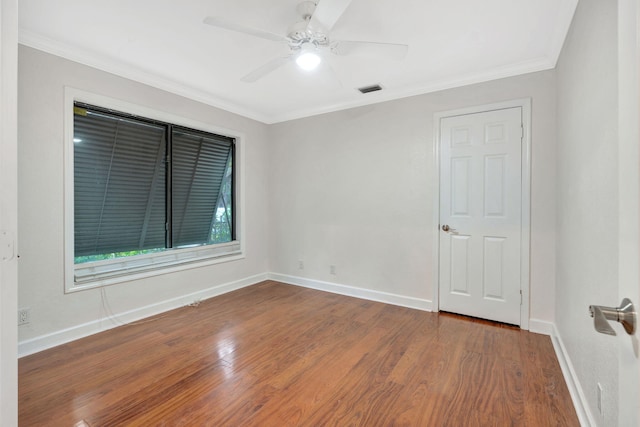 empty room with wood-type flooring, ceiling fan, and crown molding