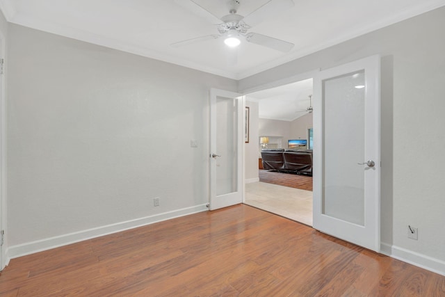 unfurnished bedroom featuring ornamental molding, ceiling fan, french doors, and hardwood / wood-style floors