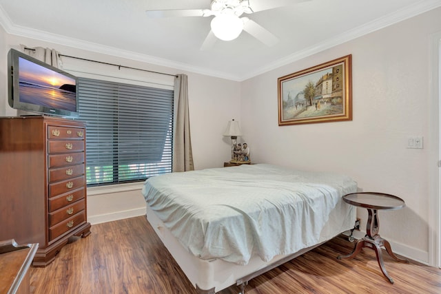 bedroom with ceiling fan, ornamental molding, and dark hardwood / wood-style flooring