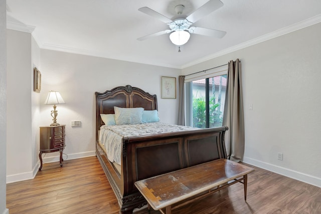 bedroom featuring crown molding, light hardwood / wood-style flooring, and ceiling fan