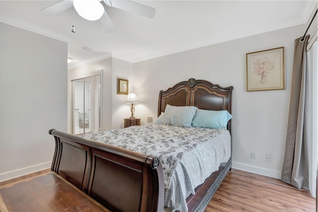 bedroom featuring light wood-type flooring, a closet, ceiling fan, and ornamental molding