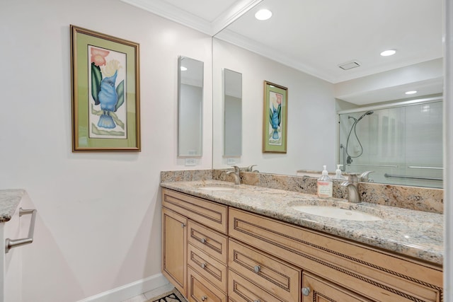 bathroom featuring a shower with shower door, tile patterned floors, vanity, and crown molding