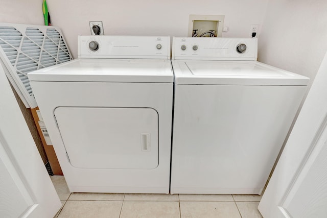 washroom featuring separate washer and dryer and light tile patterned flooring