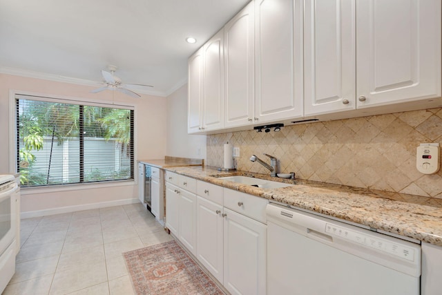 kitchen featuring white appliances, tasteful backsplash, light stone countertops, and white cabinetry