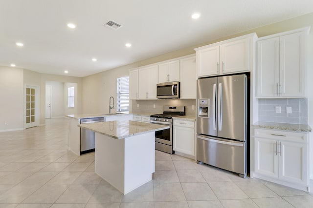 kitchen featuring appliances with stainless steel finishes, a center island, and white cabinetry