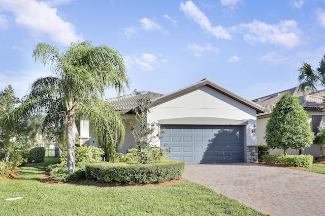 ranch-style house featuring a front yard and a garage