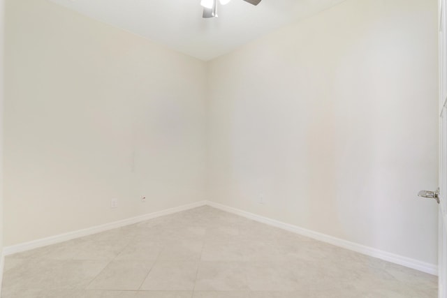 tiled spare room featuring ceiling fan