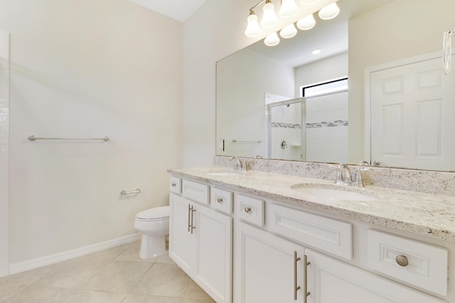 bathroom featuring vanity, a shower with door, tile patterned flooring, and toilet