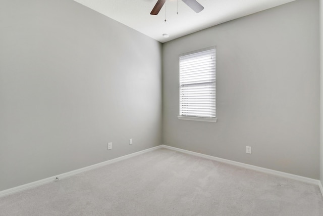 empty room with ceiling fan and light carpet