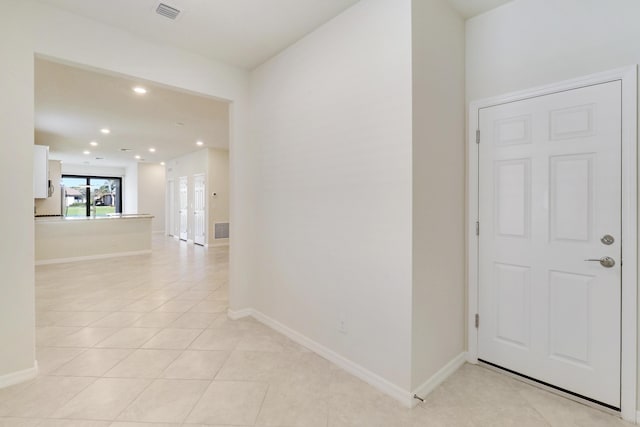 hallway featuring light tile patterned floors