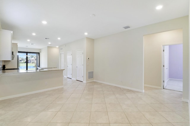 interior space with light tile patterned floors and sink