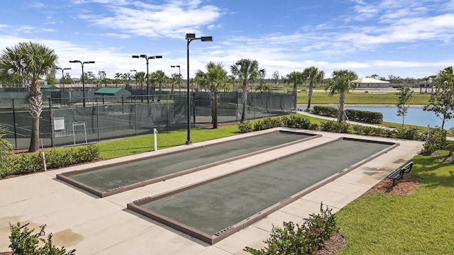 view of property's community featuring a yard and a water view