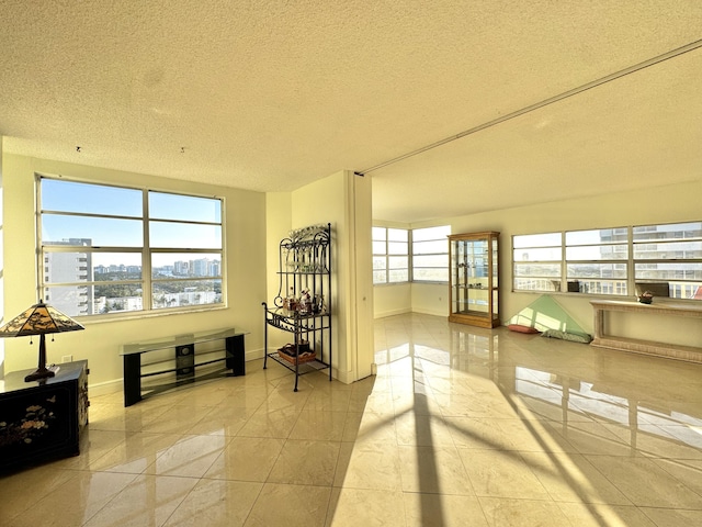 interior space with light tile patterned floors and a textured ceiling