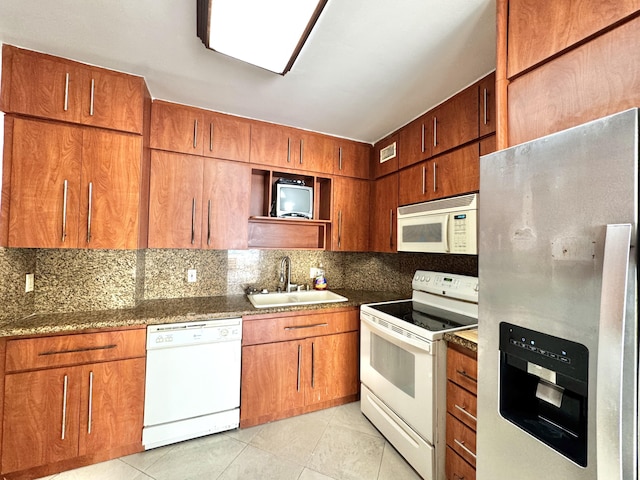 kitchen featuring light tile patterned floors, white appliances, backsplash, and sink