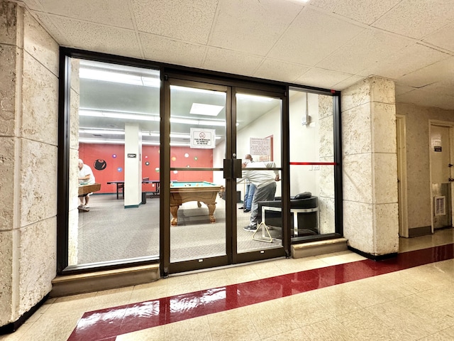 entryway with a drop ceiling and pool table