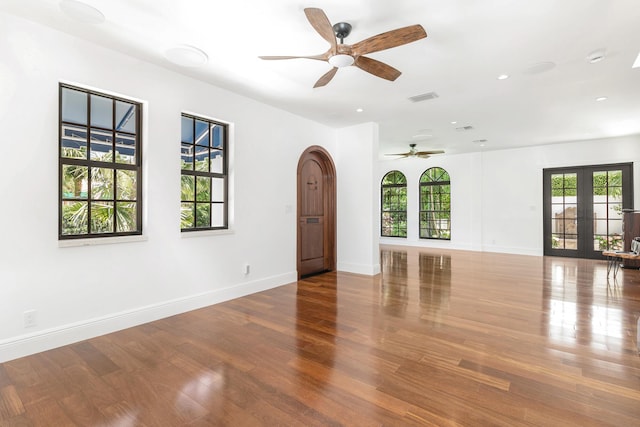 spare room featuring wood-type flooring, french doors, and ceiling fan