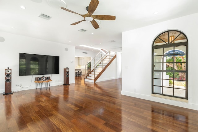 unfurnished living room with hardwood / wood-style floors and ceiling fan