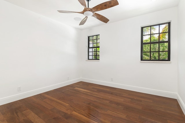 unfurnished room featuring ceiling fan, plenty of natural light, and dark hardwood / wood-style floors