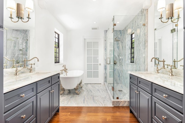 bathroom featuring vanity, hardwood / wood-style flooring, plenty of natural light, and independent shower and bath