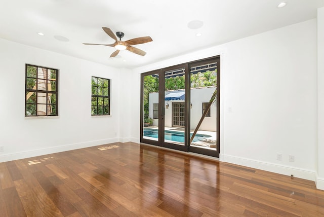 spare room with hardwood / wood-style floors, french doors, and ceiling fan