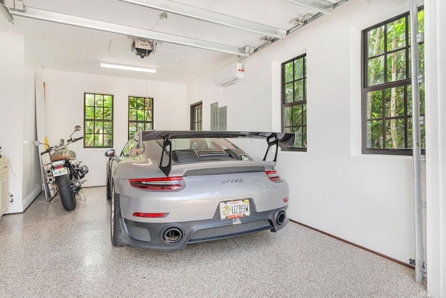 garage featuring a garage door opener, electric panel, and an AC wall unit