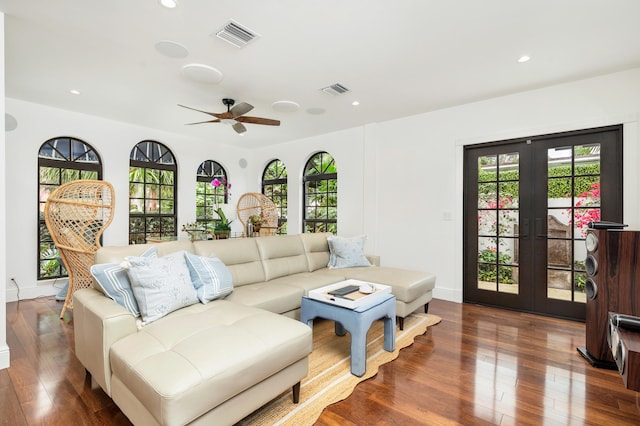 living room with dark wood-type flooring and french doors