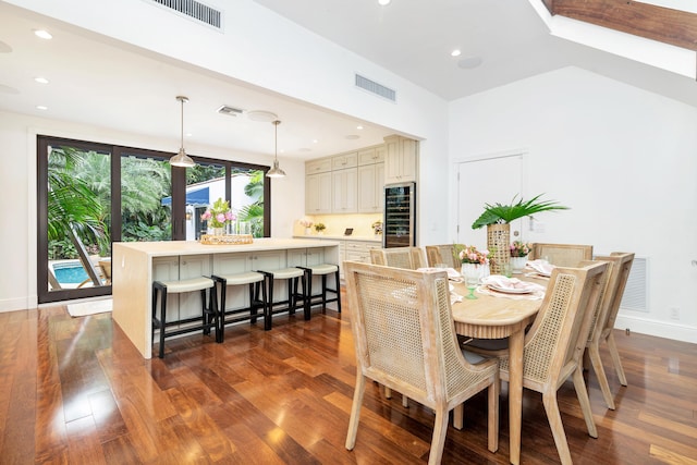 dining area with dark hardwood / wood-style floors and wine cooler