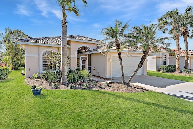 mediterranean / spanish-style house with a garage and a front yard