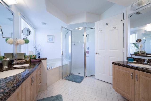 bathroom featuring shower with separate bathtub, vanity, and tile patterned floors