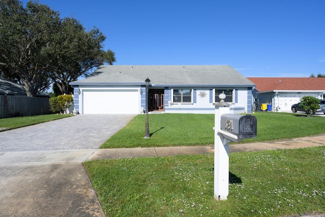 ranch-style house featuring a front yard and a garage