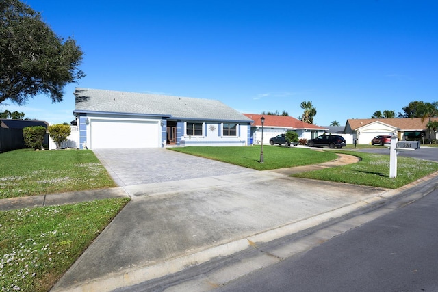 view of front of property with a front yard and a garage