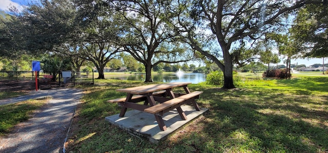 view of property's community with a yard and a water view