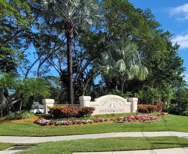 community / neighborhood sign with a yard