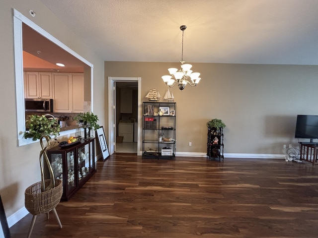 dining space featuring dark wood-type flooring and a chandelier