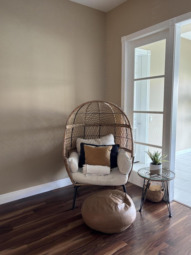 sitting room with dark wood-type flooring