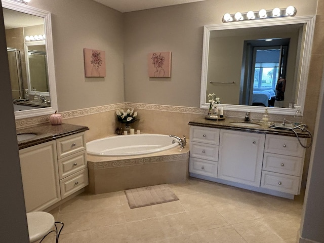 bathroom featuring tile patterned floors, plus walk in shower, and vanity