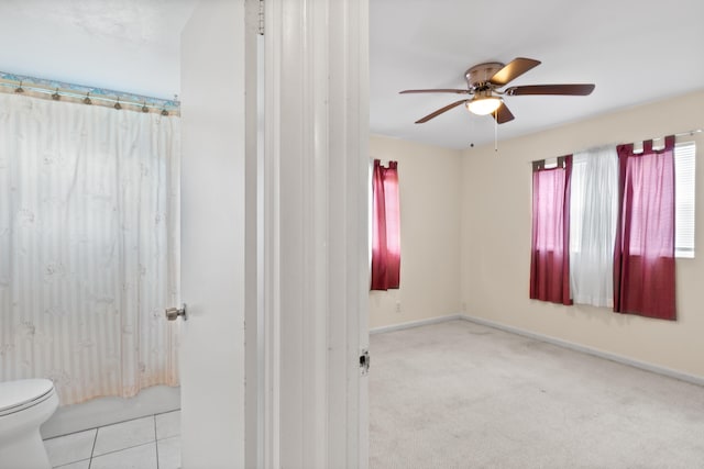 bathroom featuring toilet and ceiling fan