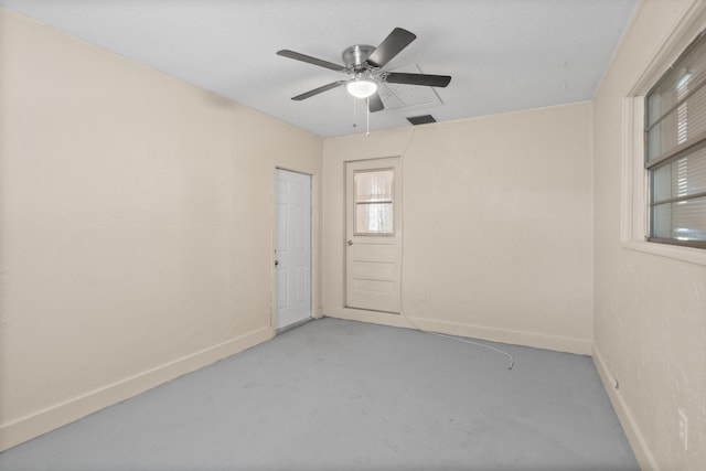 empty room featuring ceiling fan and concrete flooring