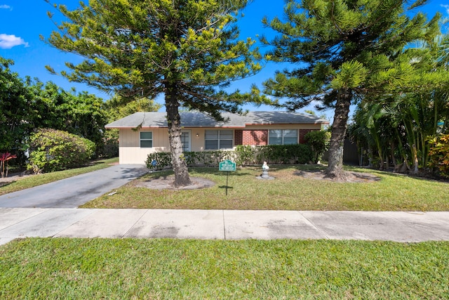 ranch-style home featuring a front yard