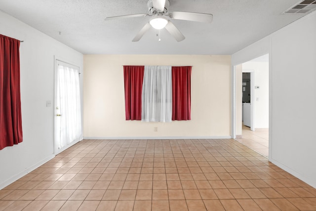 unfurnished room featuring ceiling fan, a textured ceiling, and light tile patterned floors